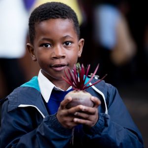 School Food Matters photo of a school child holding beetroot