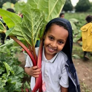 School Food Matters photo of school child holding rhubarb