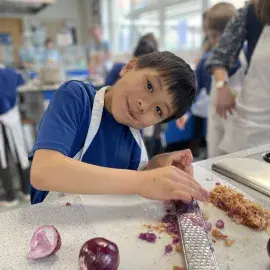 Child at a Schools to Market cooking session